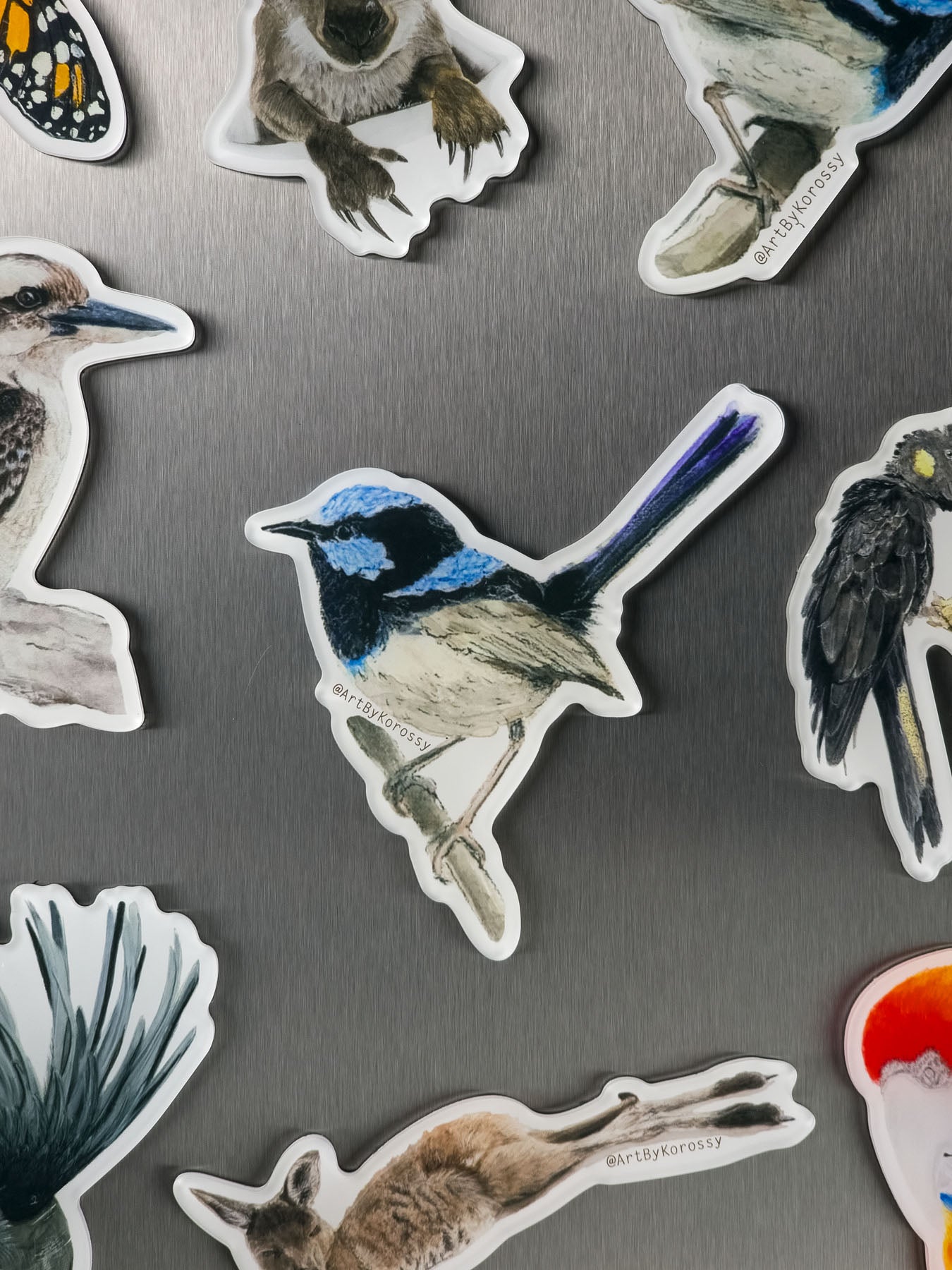 Collection of animal magnets on a gray steel fridge surface